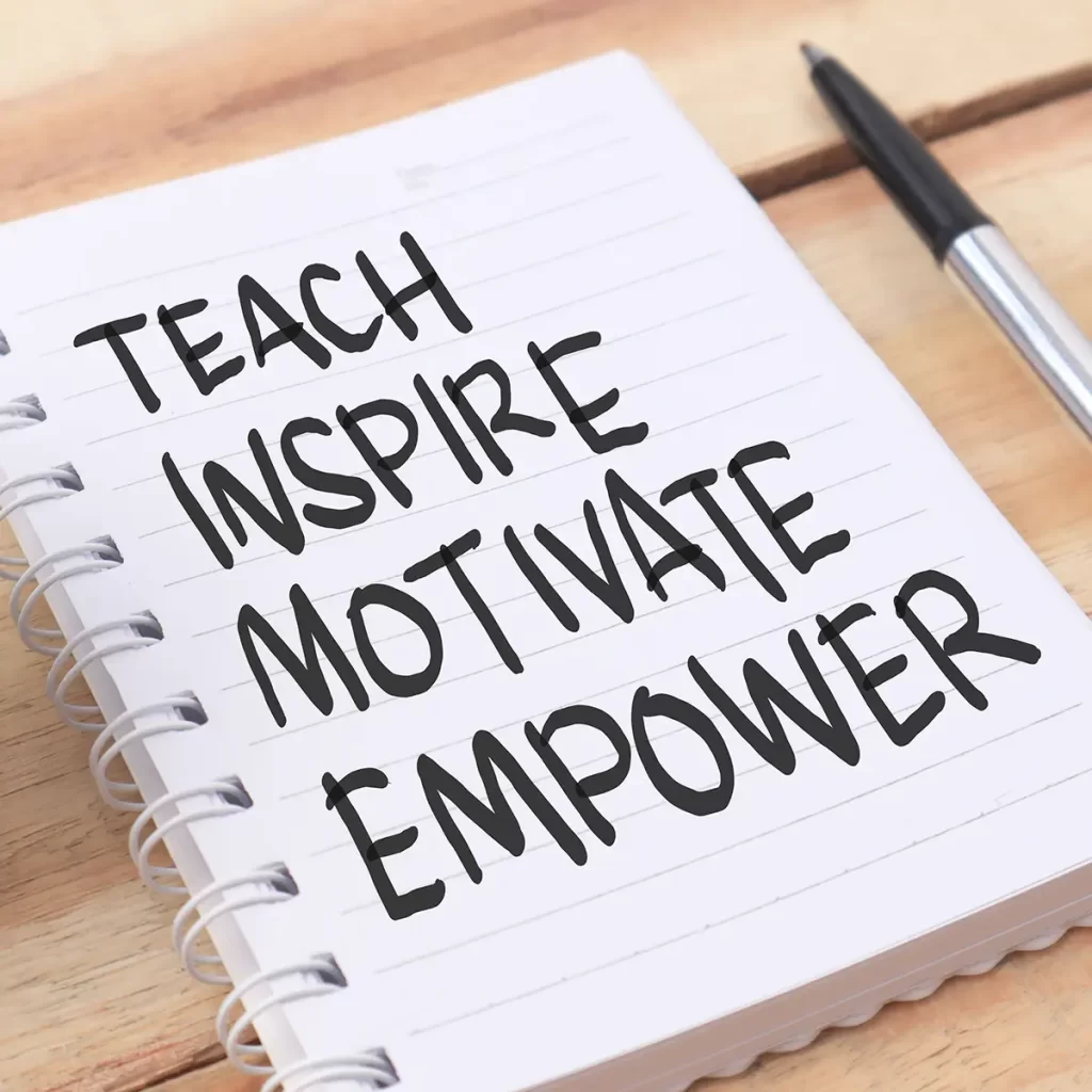 Teach, Inspire, Motivate, Empower written on notebook